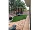 Landscaped backyard with artificial turf and patio at 9703 Newport Coast Cir, Las Vegas, NV 89147