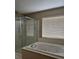 Bright bathroom features a separate glass-enclosed shower and a luxurious soaking tub at 10046 Dancing Lasso Ct, Las Vegas, NV 89178