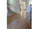Welcoming foyer with tile flooring and a view into the living room and staircase at 10046 Dancing Lasso Ct, Las Vegas, NV 89178