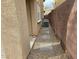 A side yard features a stepping stone walkway and gravel ground cover at 10046 Dancing Lasso Ct, Las Vegas, NV 89178