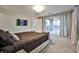 Main bedroom with private balcony and large TV at 10226 Jade Gardens Dr, Las Vegas, NV 89135