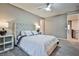 Serene bedroom with a tufted headboard and ceiling fan at 10226 Jade Gardens Dr, Las Vegas, NV 89135