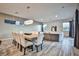 Bright dining room with seating for eight, adjacent to living room at 10226 Jade Gardens Dr, Las Vegas, NV 89135