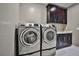 Laundry room with dark cabinets, washer, and dryer at 10226 Jade Gardens Dr, Las Vegas, NV 89135