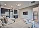 Spacious living room featuring a sectional sofa and a wall-mounted TV at 10226 Jade Gardens Dr, Las Vegas, NV 89135