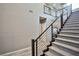 Contemporary staircase with metal railing leading to the second floor at 10226 Jade Gardens Dr, Las Vegas, NV 89135