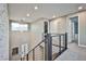 Upstairs hallway with modern railing and stone accent wall at 10226 Jade Gardens Dr, Las Vegas, NV 89135