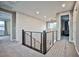 Modern upper hallway with stone feature wall and metal railing at 10226 Jade Gardens Dr, Las Vegas, NV 89135