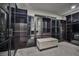 Large walk-in closet featuring glass-front cabinets and a bench at 10226 Jade Gardens Dr, Las Vegas, NV 89135