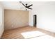 Bright bedroom with light taupe accent wall and wood-look floors at 10229 Birch Bluff Ln, Las Vegas, NV 89145