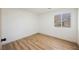 Simple bedroom with wood-look floors and a window with natural light at 10229 Birch Bluff Ln, Las Vegas, NV 89145