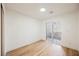 Bright bedroom with light wood flooring and sliding glass door to patio at 10229 Birch Bluff Ln, Las Vegas, NV 89145