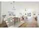 Bright dining room with hardwood floors and virtually staged furniture at 10229 Birch Bluff Ln, Las Vegas, NV 89145