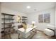 Virtually staged home office features built-in shelving and a modern desk at 10229 Birch Bluff Ln, Las Vegas, NV 89145