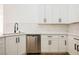 Modern kitchen with white cabinets, quartz countertops, and stainless steel dishwasher at 10229 Birch Bluff Ln, Las Vegas, NV 89145