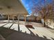 Spacious backyard with covered patio, mature trees, and basketball court at 1113 Dawn Valley Dr, North Las Vegas, NV 89031