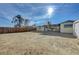 Large backyard with a view of the house and storage shed at 1212 Reynolds Ave, North Las Vegas, NV 89030