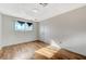 This bedroom features wood flooring and a window for natural light at 1212 Reynolds Ave, North Las Vegas, NV 89030