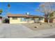 Charming single-story home featuring a spacious front yard and a long concrete driveway at 1212 Reynolds Ave, North Las Vegas, NV 89030