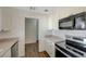 Well-equipped kitchen featuring stainless steel oven, microwave, bright white cabinets and durable countertops at 1212 Reynolds Ave, North Las Vegas, NV 89030