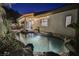 Inviting freeform pool with waterfall feature and landscaped surroundings at 140 Cora Hills Ct, Las Vegas, NV 89148