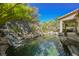 Resort-style backyard oasis featuring a tranquil pool, waterfall, and relaxing spa at 140 Cora Hills Ct, Las Vegas, NV 89148