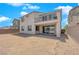 Two story home with backyard, grassy area and a patio at 1606 Dire Wolf Ave, North Las Vegas, NV 89084