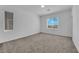 Bright bedroom with neutral carpeting and window at 1606 Dire Wolf Ave, North Las Vegas, NV 89084