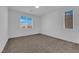 Bright bedroom with carpet flooring and two windows at 1606 Dire Wolf Ave, North Las Vegas, NV 89084