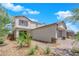 Two-story house with gray exterior, paver walkway, and landscaping at 1606 Dire Wolf Ave, North Las Vegas, NV 89084