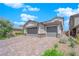 Two-story house with gray exterior, paver driveway, and landscaping at 1606 Dire Wolf Ave, North Las Vegas, NV 89084