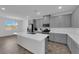 Modern kitchen with gray cabinets, white countertops, and stainless steel appliances at 1606 Dire Wolf Ave, North Las Vegas, NV 89084