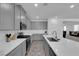 Modern kitchen featuring gray cabinets, quartz countertops, and stainless steel appliances at 1606 Dire Wolf Ave, North Las Vegas, NV 89084