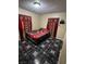 Bedroom with tile floors and red floral bedding at 217 Jackson Ave, Las Vegas, NV 89106