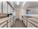 Bright kitchen with white cabinets, laminate flooring, and a microwave at 2300 Silverado Ranch Blvd # 1070, Las Vegas, NV 89183