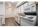 Modern kitchen with white appliances and laminate flooring at 2300 Silverado Ranch Blvd # 1070, Las Vegas, NV 89183