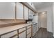 White kitchen with ample cabinet space and laminate flooring at 2300 Silverado Ranch Blvd # 1070, Las Vegas, NV 89183