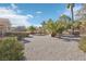 Spacious backyard with gravel and mature palm trees at 2413 Hidden Glen Ct, Las Vegas, NV 89134