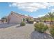 Backyard view of home with gravel and solar panels at 2413 Hidden Glen Ct, Las Vegas, NV 89134