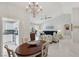 Open dining room with chandelier and view into living room at 2413 Hidden Glen Ct, Las Vegas, NV 89134