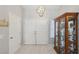 Bright entryway with double doors, tile flooring, and display cabinet at 2413 Hidden Glen Ct, Las Vegas, NV 89134