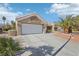 Front view of the house showcasing a garage and driveway at 2413 Hidden Glen Ct, Las Vegas, NV 89134