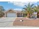 Single-story home with a two-car garage and desert landscaping at 2413 Hidden Glen Ct, Las Vegas, NV 89134