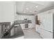 Modern kitchen with white cabinets, gray countertops, and tile backsplash at 2413 Hidden Glen Ct, Las Vegas, NV 89134