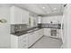 Modern white kitchen with gray countertops and tile backsplash at 2413 Hidden Glen Ct, Las Vegas, NV 89134