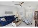 Open living area with a navy couch, patterned chairs, and a coffee table at 2413 Hidden Glen Ct, Las Vegas, NV 89134