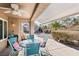 Outdoor patio with seating area, ceiling fan, and partial view of backyard at 2413 Hidden Glen Ct, Las Vegas, NV 89134