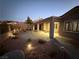 Landscaped backyard with patio, lighting, and seating area at 2568 Dirleton Pl, Henderson, NV 89044