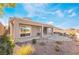 Backyard featuring a covered patio, landscaping, and desert rock at 2568 Dirleton Pl, Henderson, NV 89044