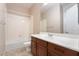 Bathroom with tub, toilet and vanity with wood cabinets at 2568 Dirleton Pl, Henderson, NV 89044